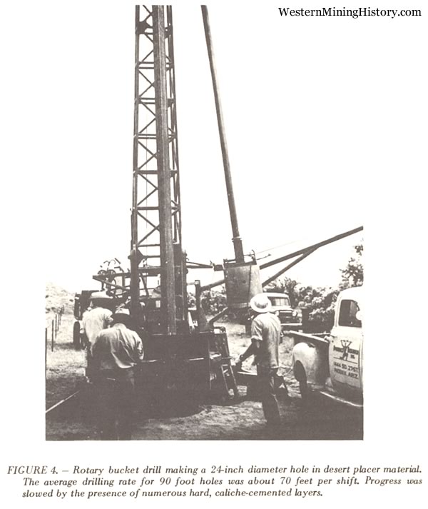 Rotary bucket drill making a 24-inch diameter hole in desert placer material